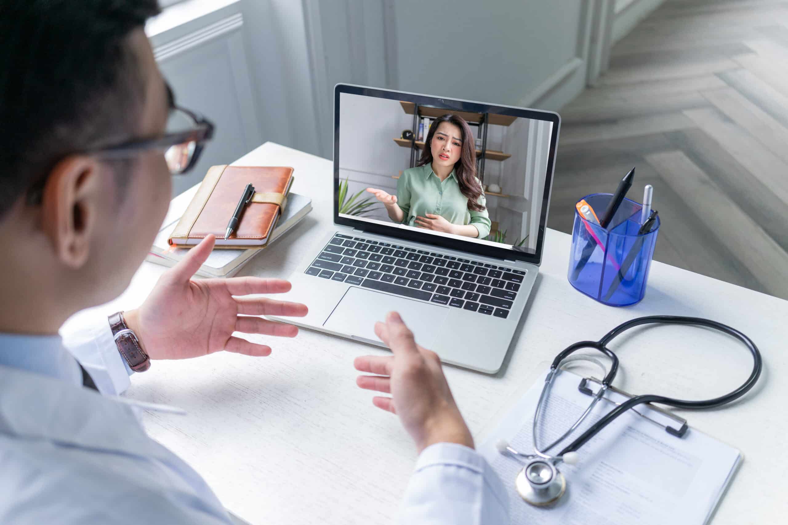 A chronic pain patient consults her doctor through telemedicine, an EMR solution for pain management.