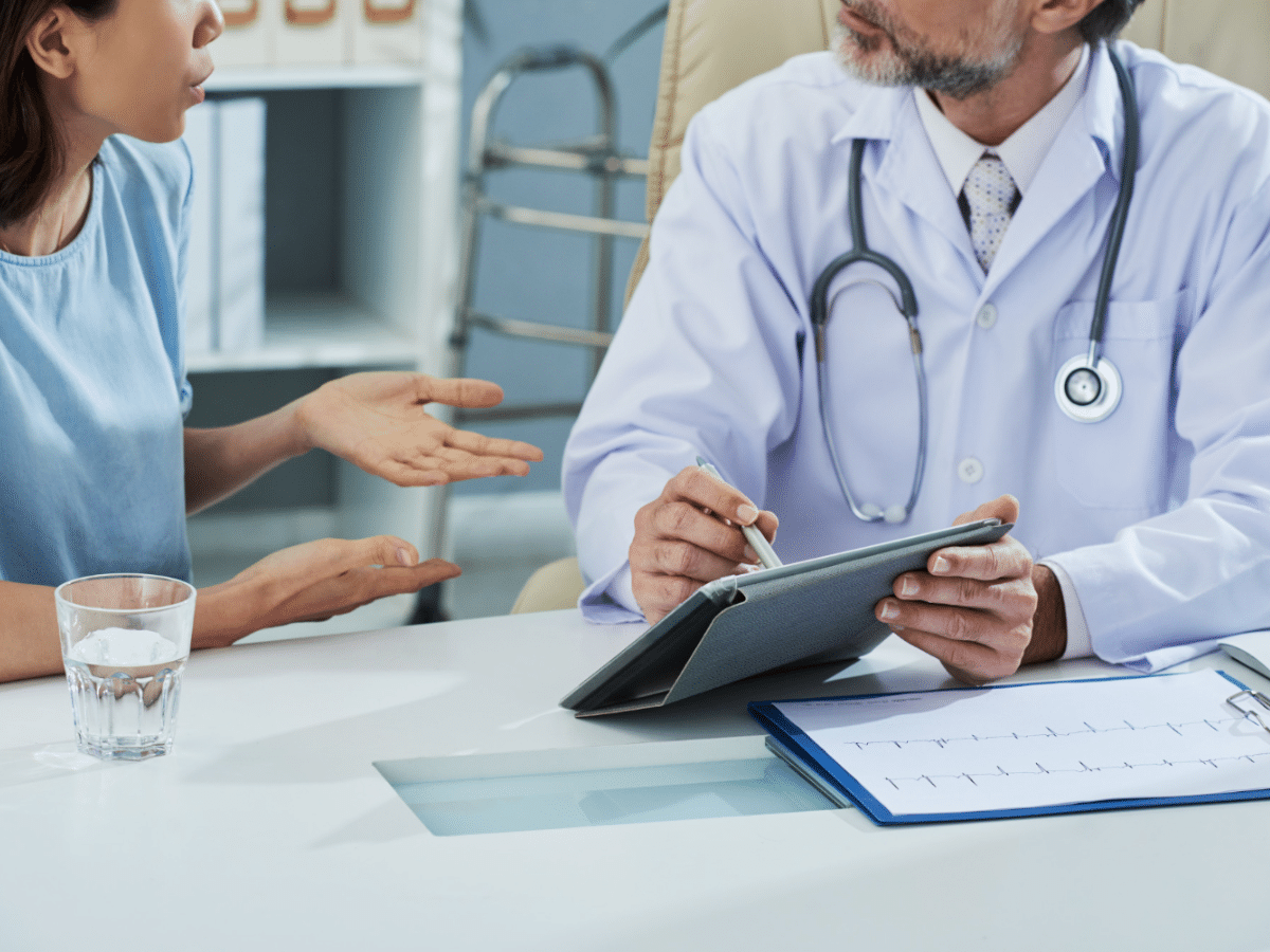  The doctor walks the patient through the digital patient intake forms, making sure to explain each detail.