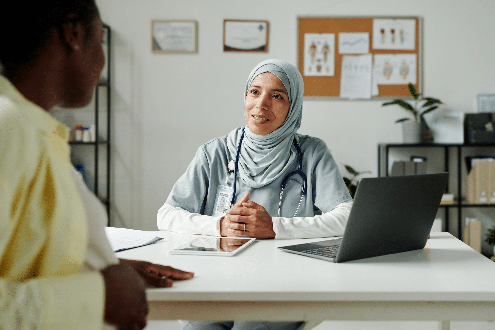 A provider talking with a patient while using IMS to simplify documentation and improve patient engagement.